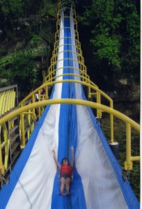 A child going down a pretty big slide
